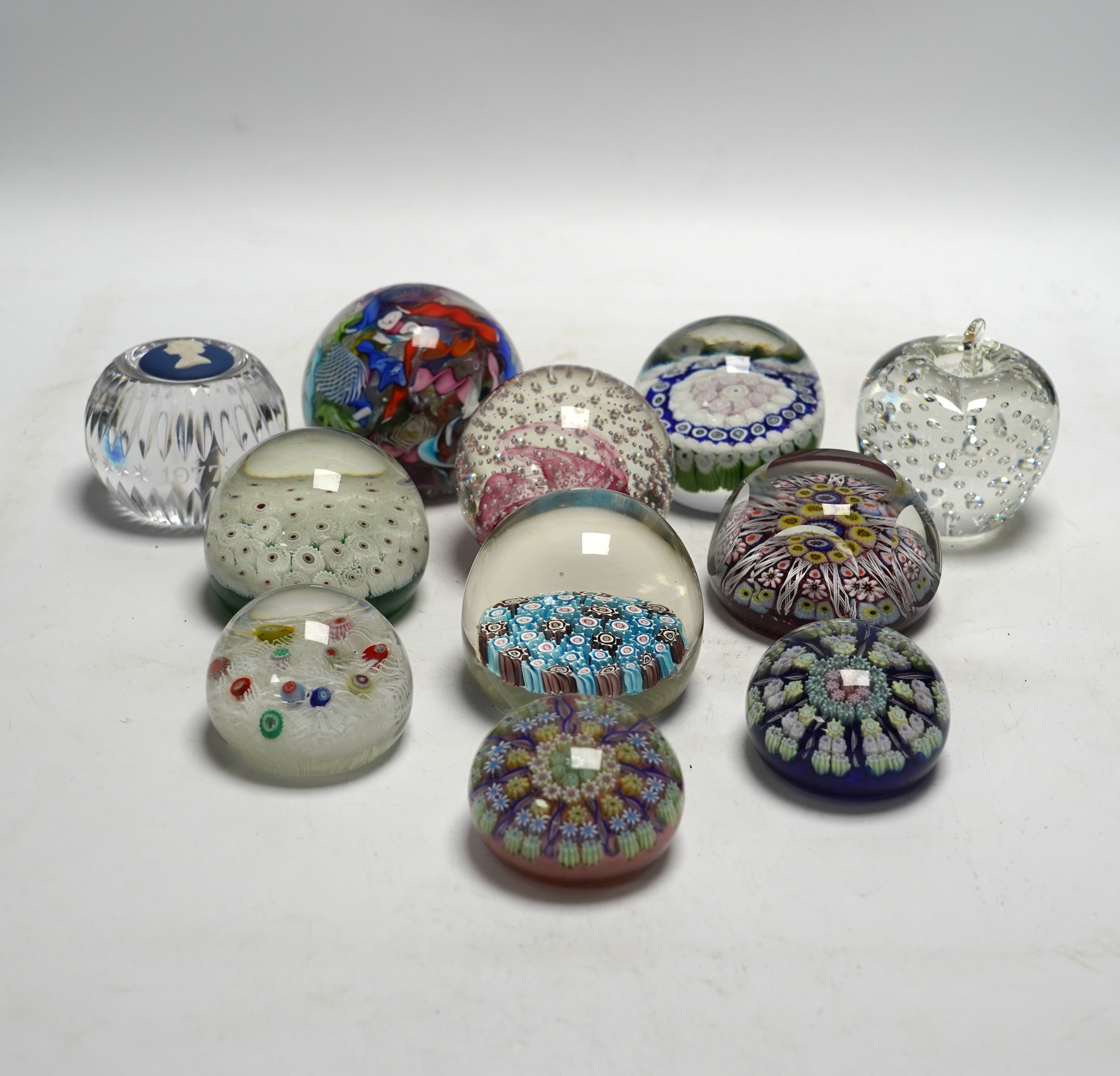 Eleven mixed Scottish and other glass paperweights including Caithness, largest 8.5cm in diameter